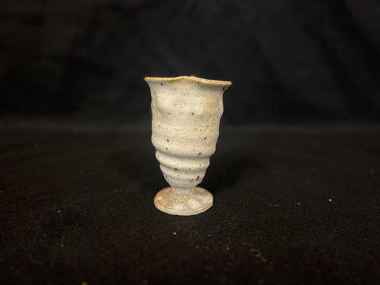 Cup flute bottom with speckled texture and swirl signature